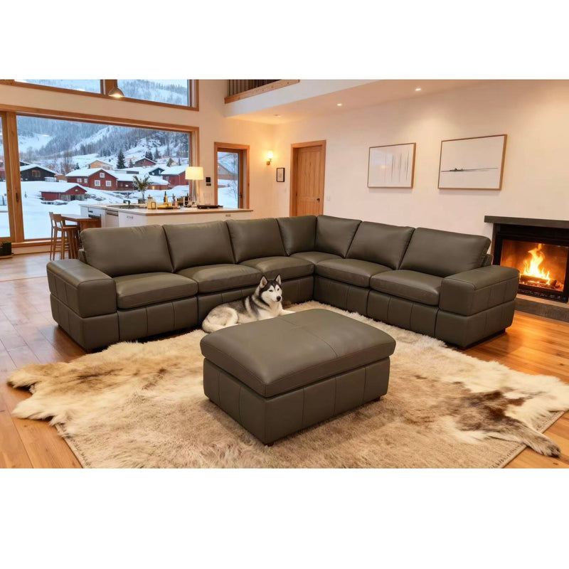 Dark green modular sectional sofa with square arms and ottoman, deep cushioned chaise