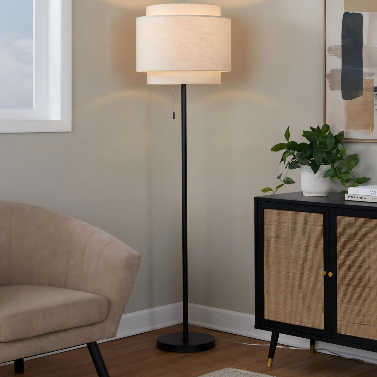 Black contemporary floor lamp with beige fabric drum shade and round base