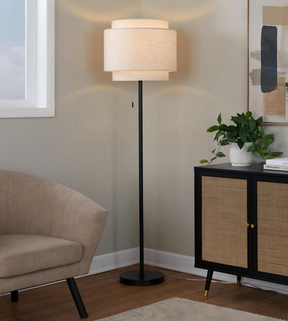 Black contemporary floor lamp with beige fabric drum shade and round base