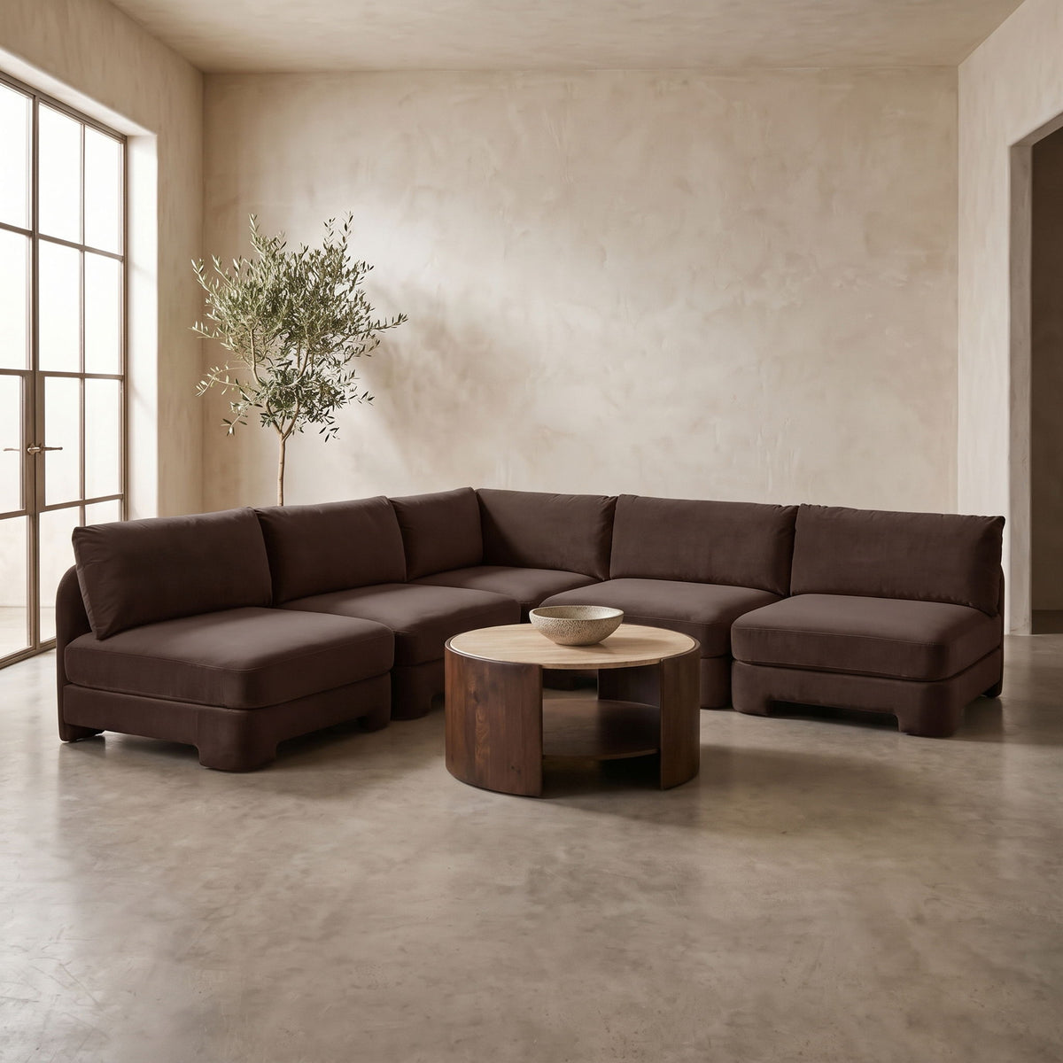 Dark brown armless velvet sectional sofa with low arms and tufted back cushions.