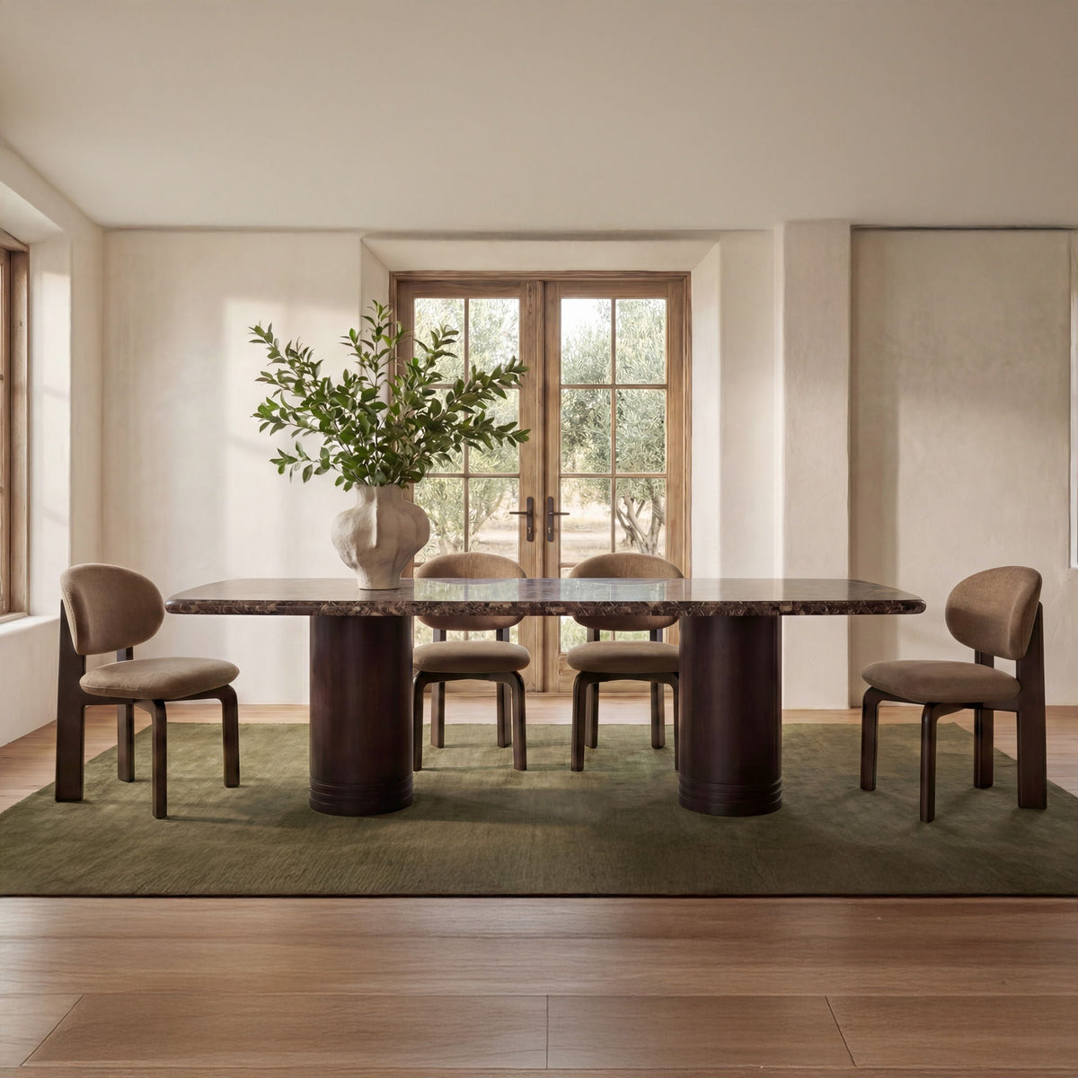 Dining table with dark marble top and brown pedestal base in a home dining room