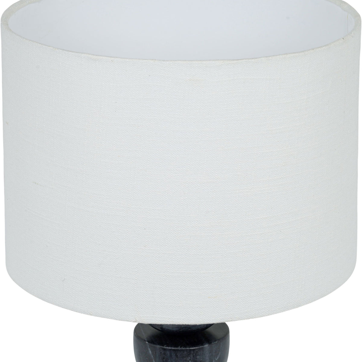 Table lamp close-up: white fabric drum shade over stacked dark marble base