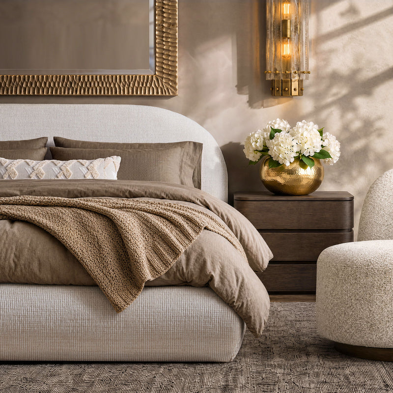 Upholstered platform bed in dark brown fabric with padded headboard and slat support