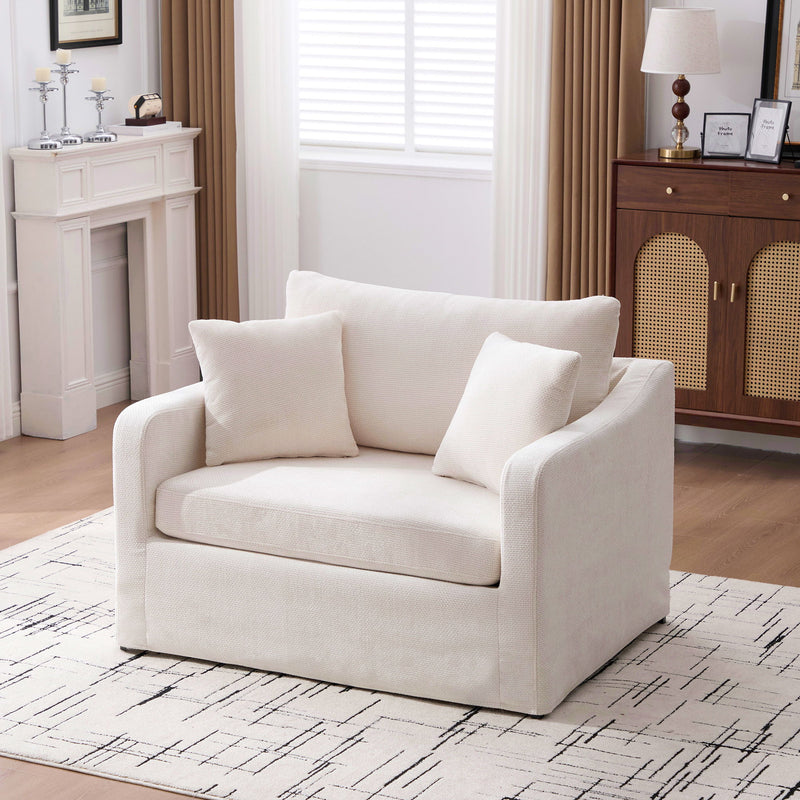 White fabric accent chair with 2 bolster pillows, wide track arms, boxy frame