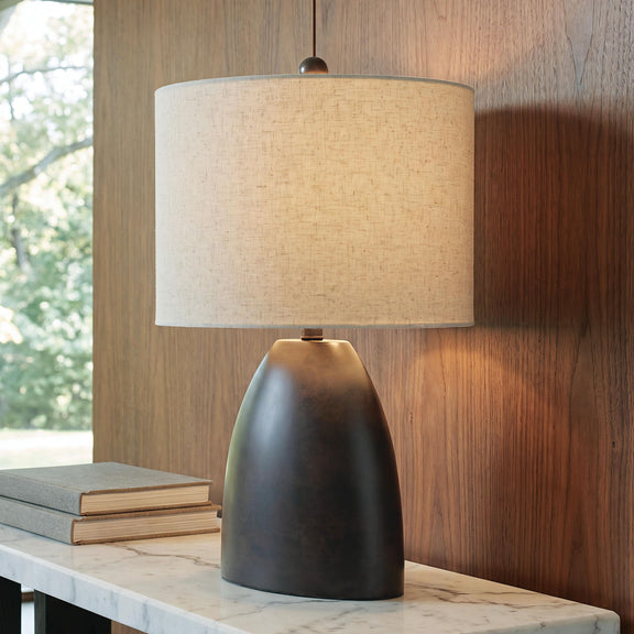 Antique black table lamp with beige fabric shade and top finial