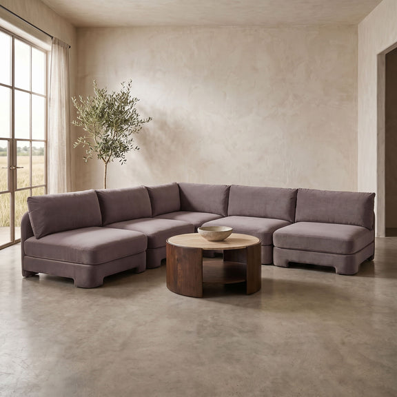 Purple-gray armless velvet sectional sofa with thick seat and back cushions.