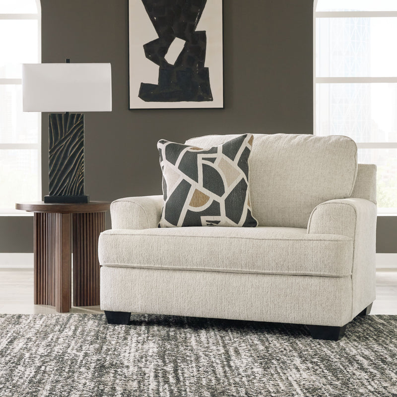 Light gray chair and a half with geometric throw pillow