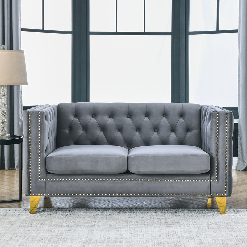 Dark gray button-tufted 3-seat sofa with rolled arms and gold nailhead trim