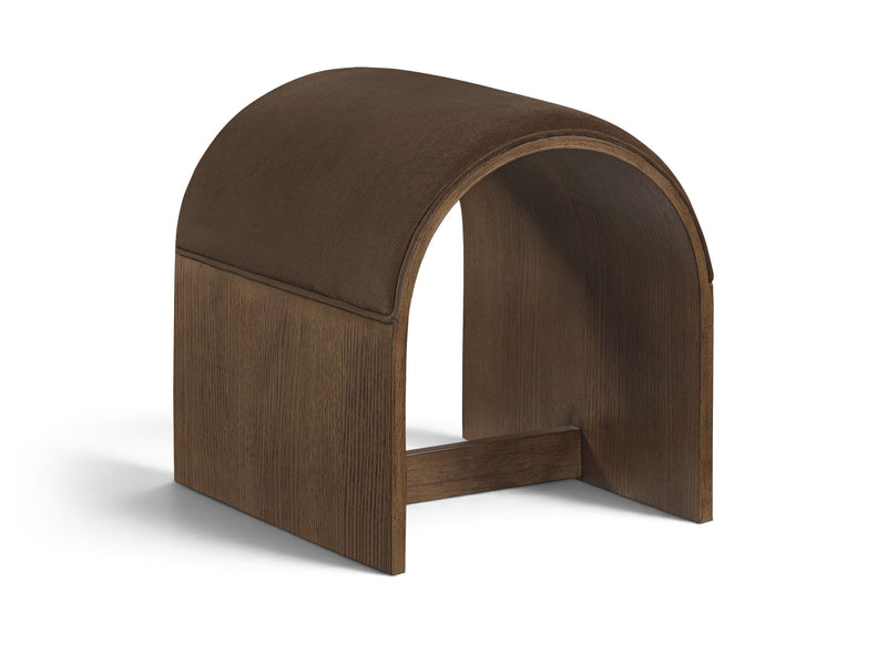Dark brown velvet upholstered bench with arched back and warm wood base, open center