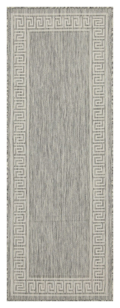 Indoor/outdoor area rug in light gray with Greek key border and textured center