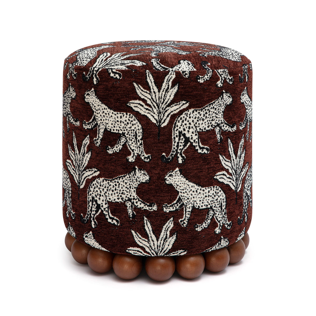 Dark brown fabric ottoman with white animal pattern and dark wood ball base.