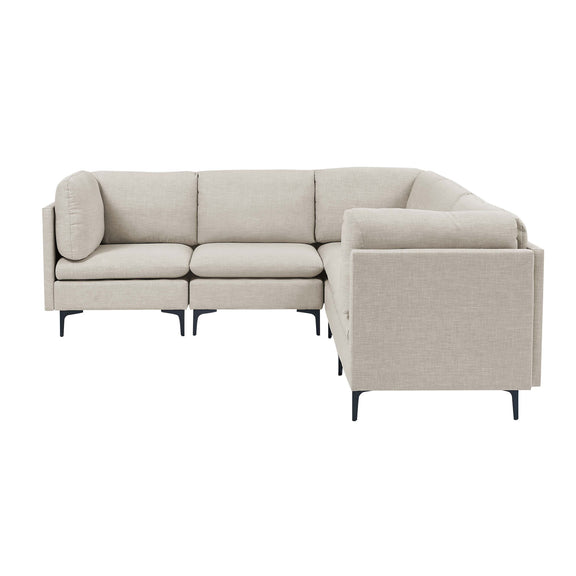 Beige modular sectional sofa with tall legs, chaise-style ottoman, and armrests