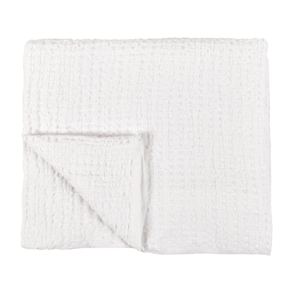 Folded white woven sham pillow with textured grid surface