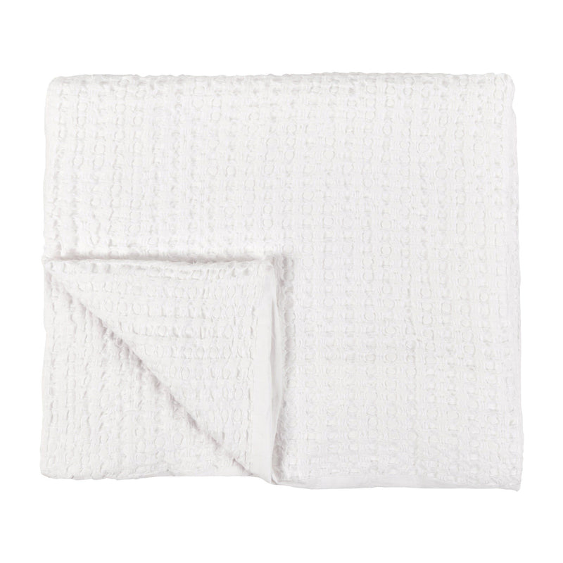 Folded white woven sham pillow with textured grid surface