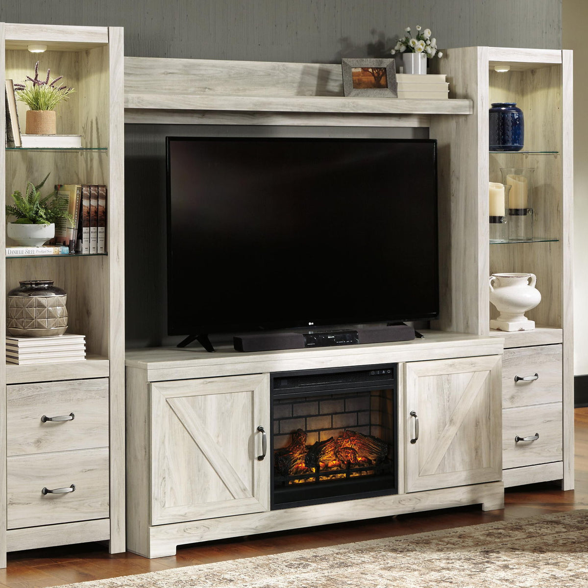 Whitewash entertainment center with TV opening and faux fireplace insert with orange flames