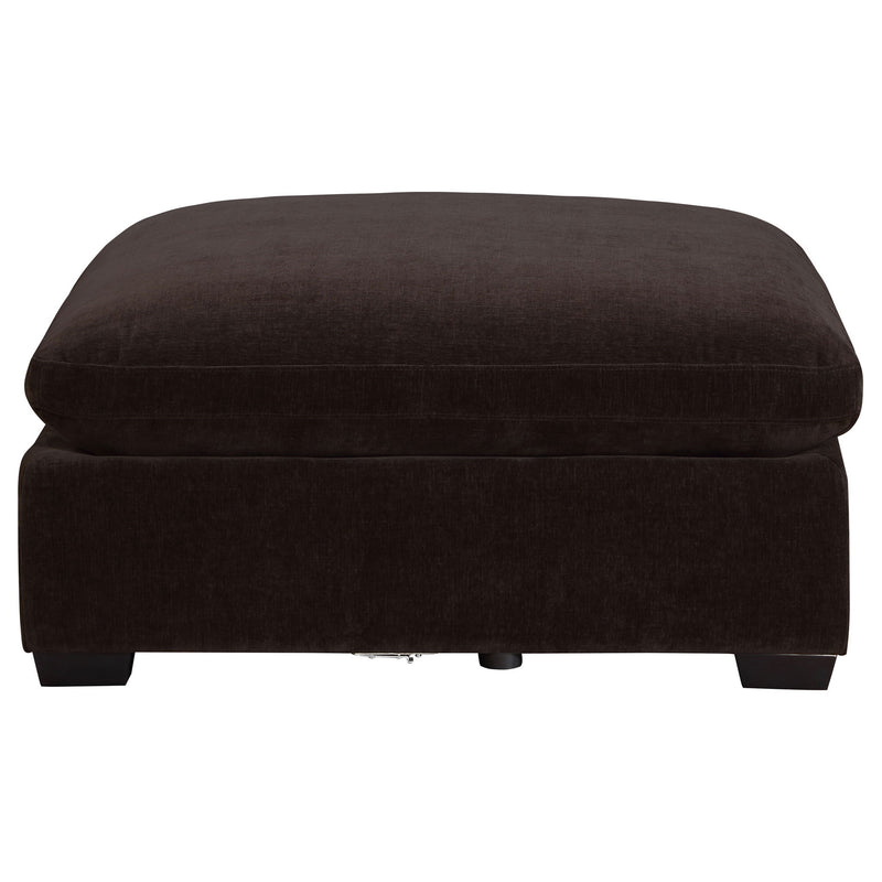 Black upholstered ottoman with thick cushion top and short wooden legs.