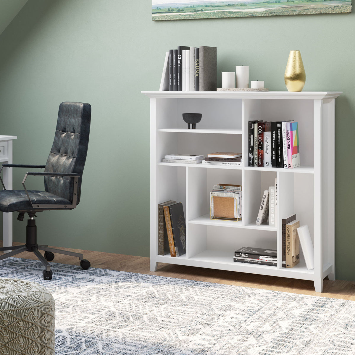 White multi-cube bookcase storage unit with open square shelves and decorative top trim.