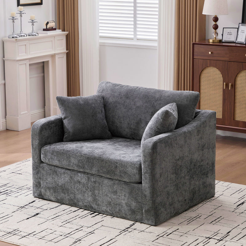 Dark gray fabric accent chair with 2 bolster pillows, thick arms, low profile