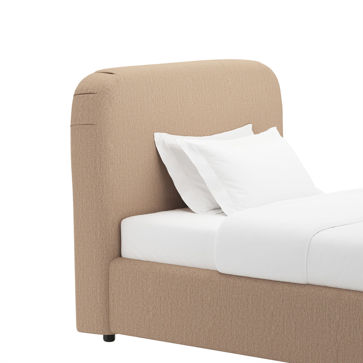 Beige rounded upholstered bed frame with curved headboard and white pillows