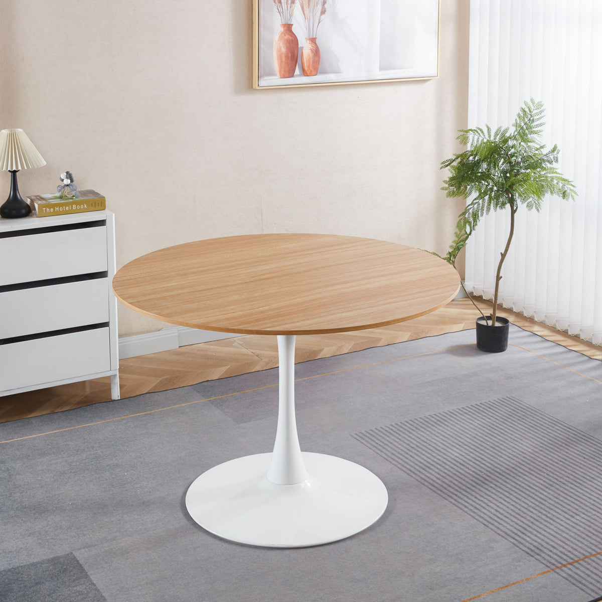 Light brown round tulip pedestal dining table with white base