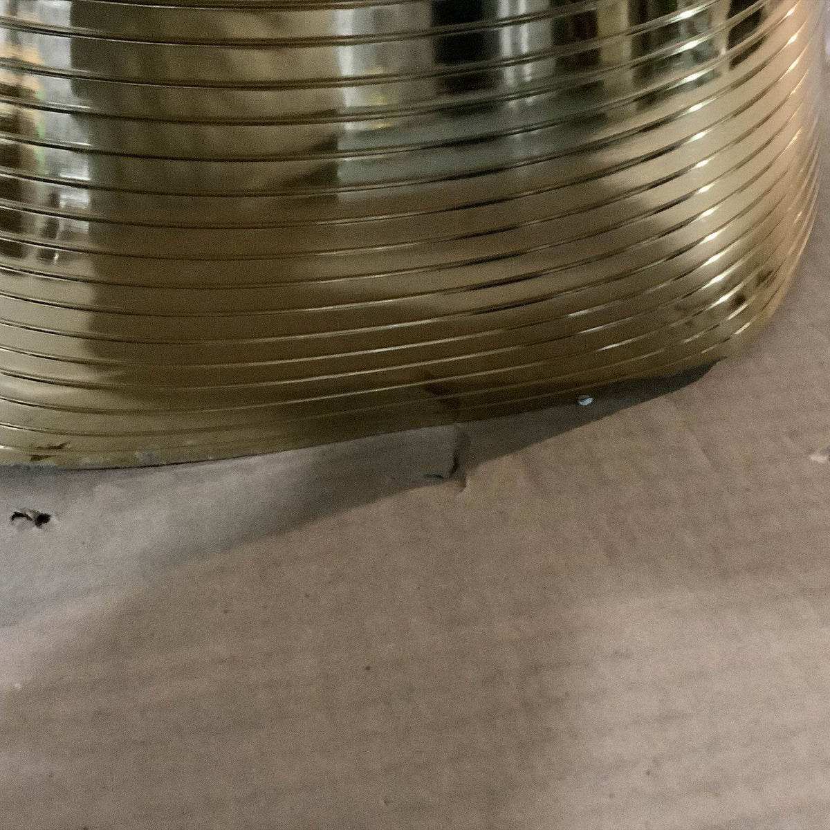 Gold-tone ribbed pedestal base on packaging, tapered cone shape