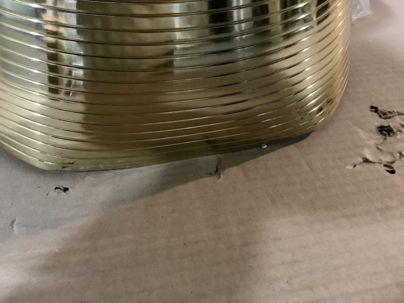 Gold-tone ribbed pedestal base on packaging, tapered cone shape