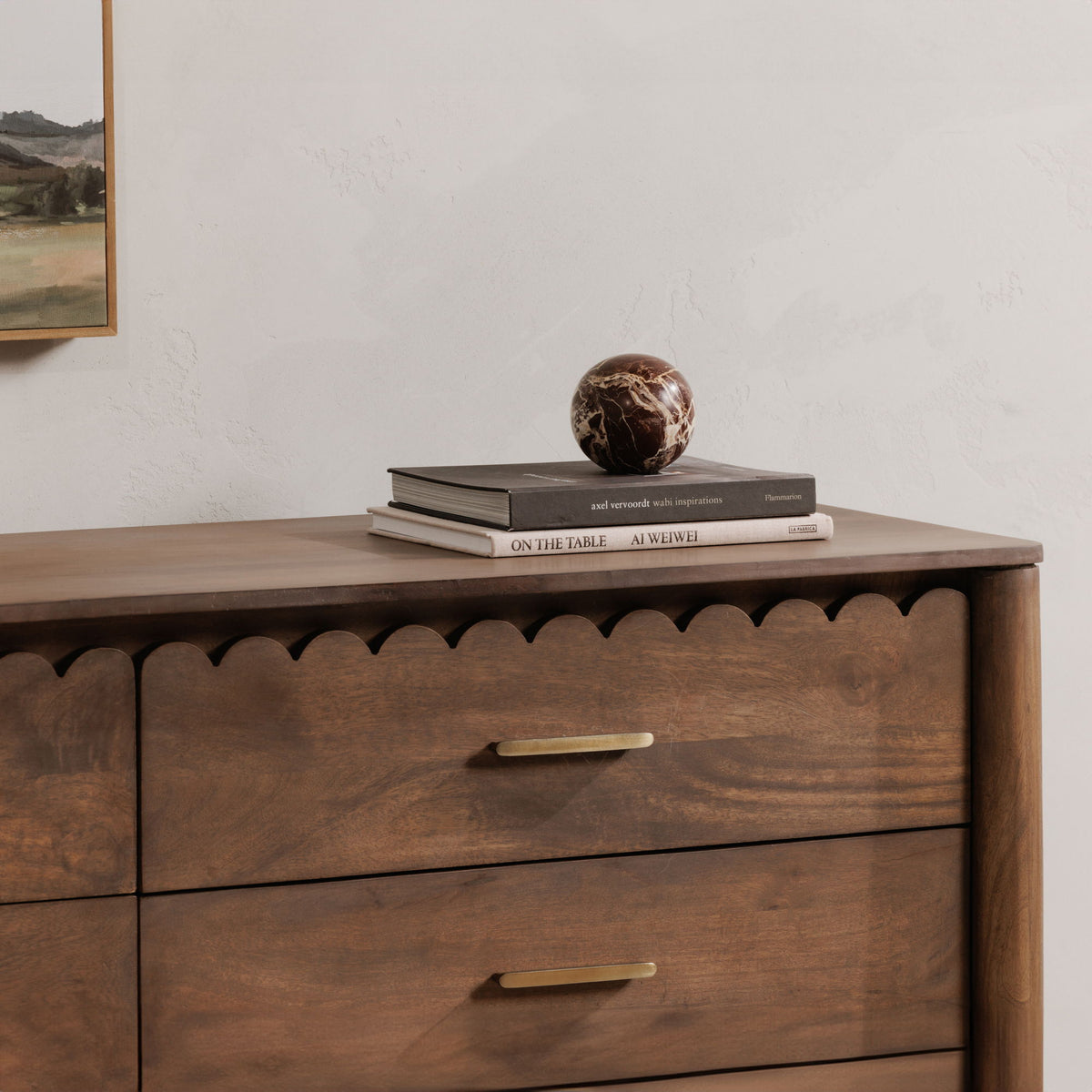 Brown dresser with rounded scalloped apron, two drawers, and gold bar handles