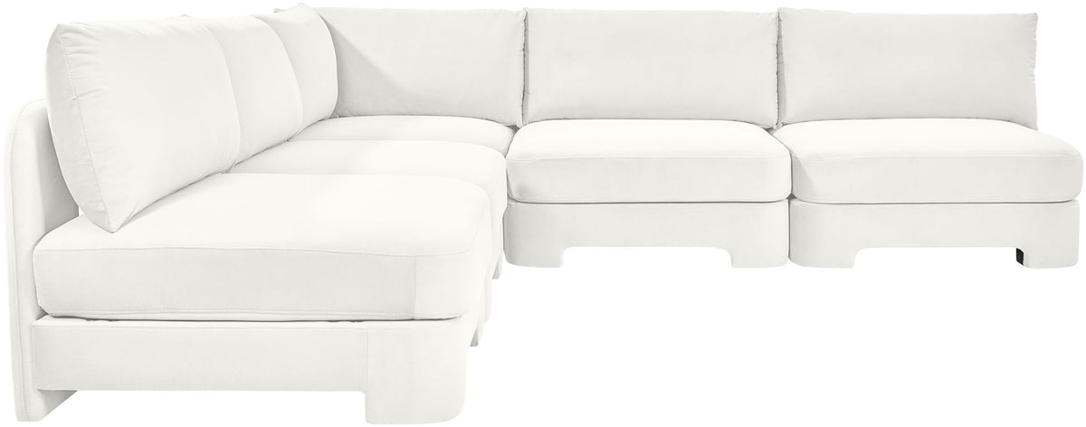White armless velvet sectional sofa with padded backrests and chaise-style seat.