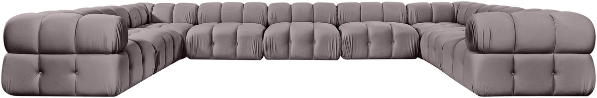 Light gray velvet sectional with tufted cushions and curved corner chaise