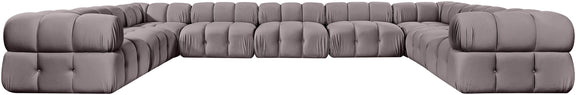 Light gray velvet sectional with tufted cushions and curved corner chaise