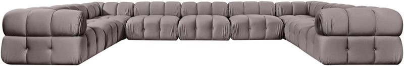 Light gray velvet sectional with tufted cushions and curved corner chaise