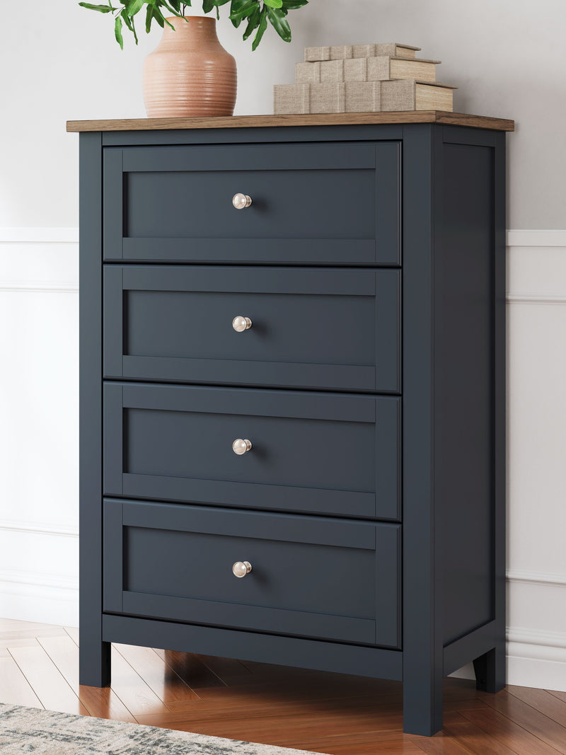 Dark blue four-drawer chest with four drawers, silver knobs, and wood top