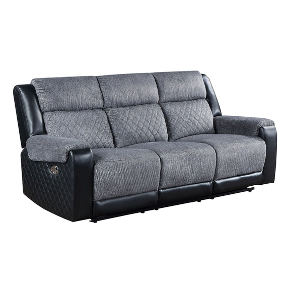 Gray reclining sofa with quilted side panels, padded arms, and split back cushions