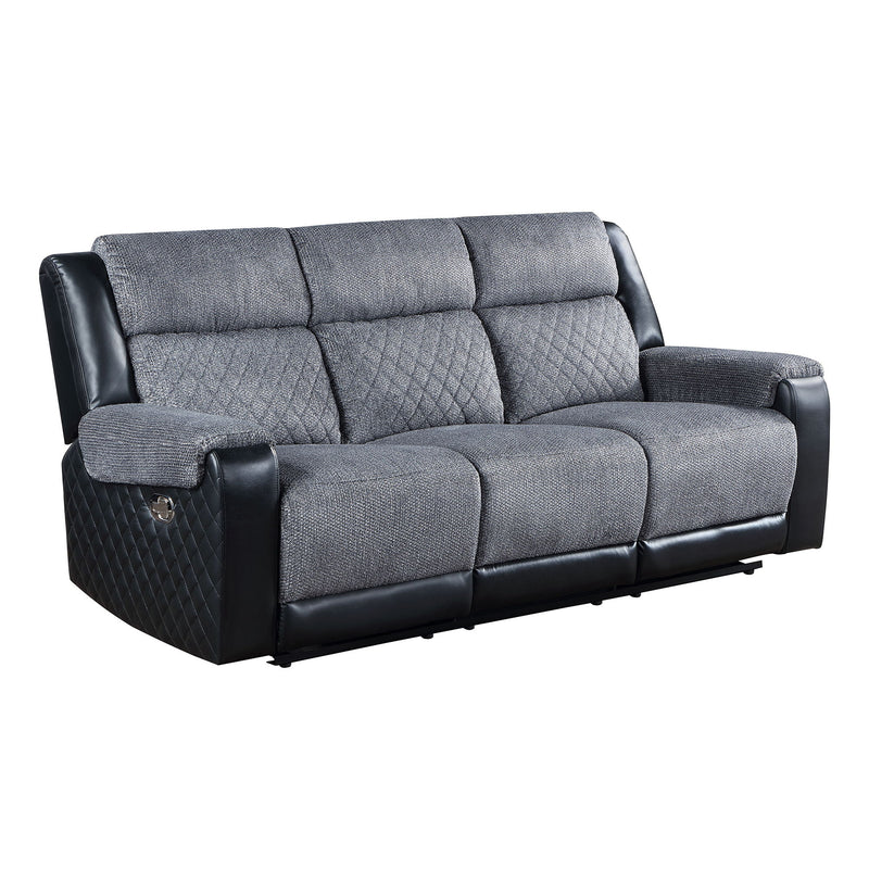 Gray reclining sofa with quilted side panels, padded arms, and split back cushions