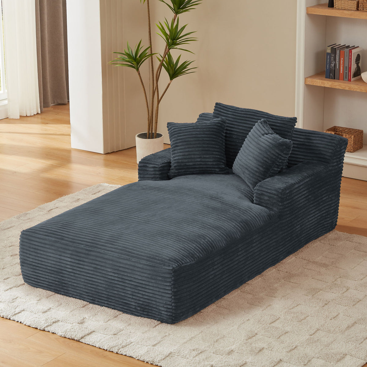 Dark gray ribbed chaise lounge with wide seat, raised arms, and three cushions