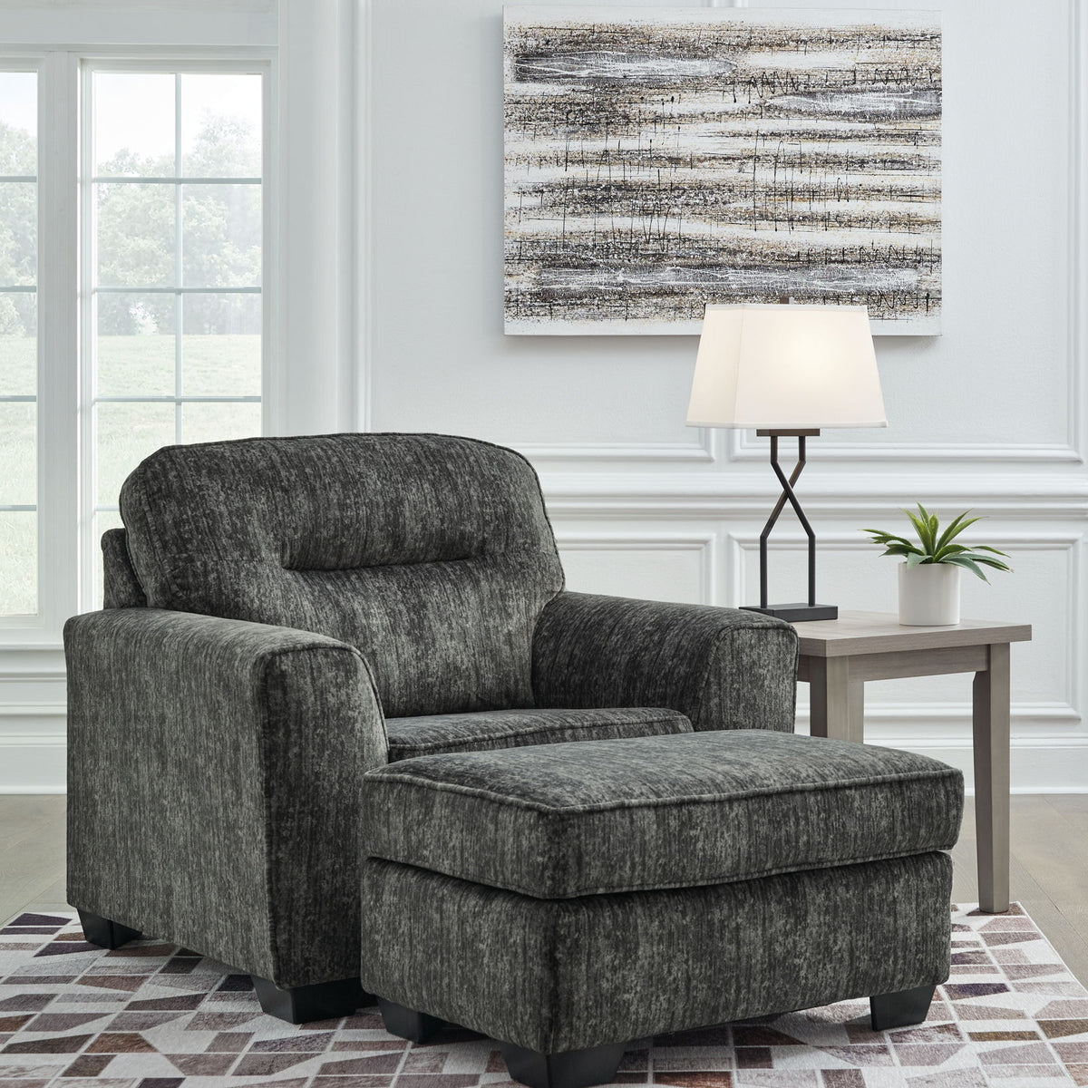 Gunmetal gray upholstered chair with rolled arms and cushioned seat and backrest