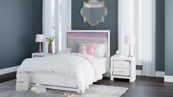 White panel bed with tufted headboard and drawer storage, styled with bedding