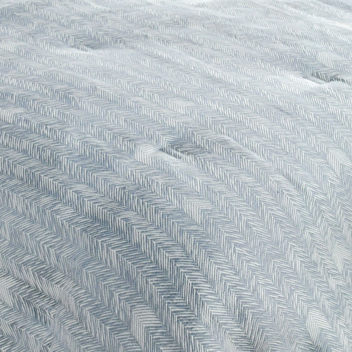 Storm blue herringbone fabric close-up with textured zigzag weave