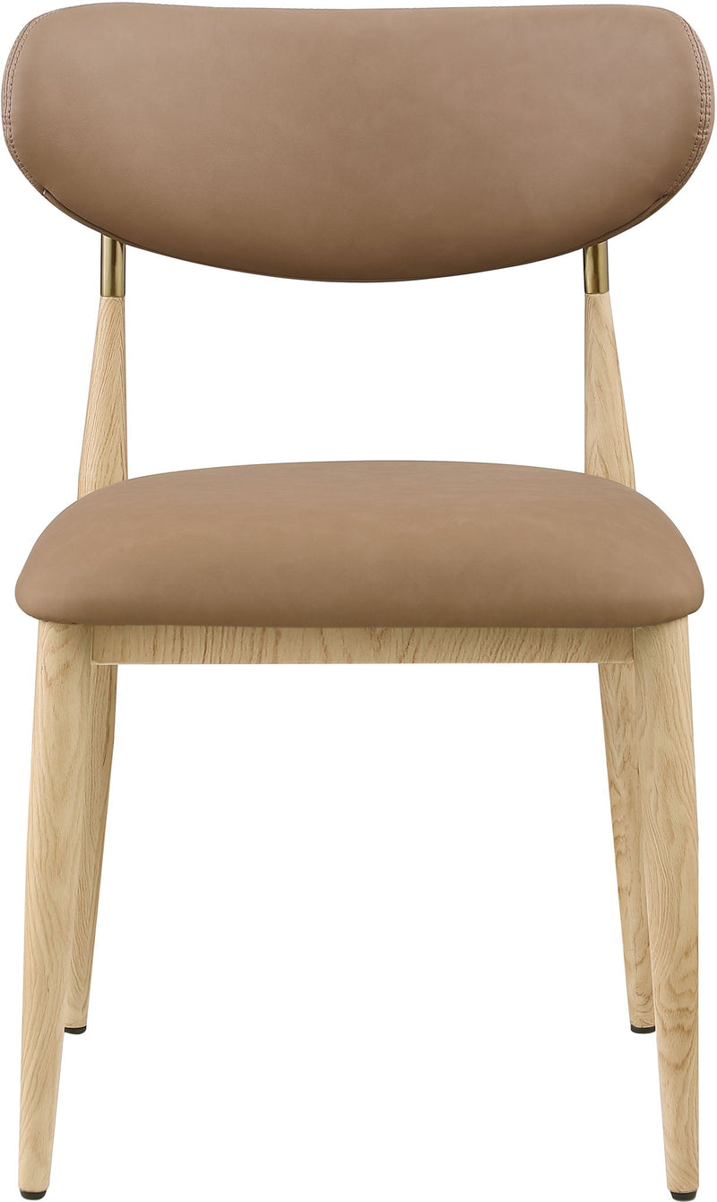 Tan upholstered dining side chair with light wood legs and brass accents