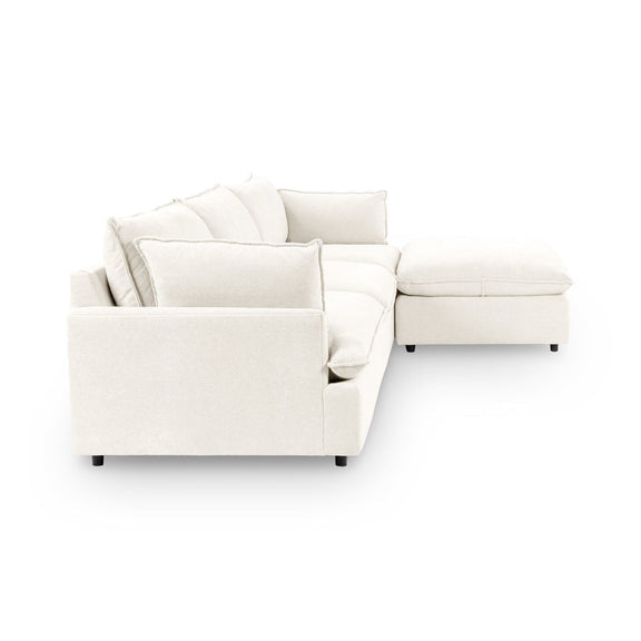 Modular sectional sofa in ivory with wide chaise and back pillows.