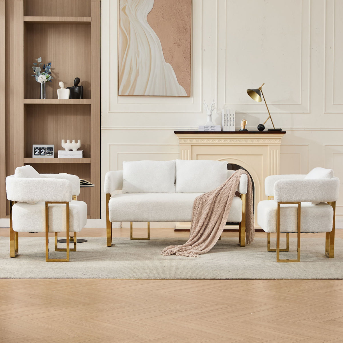 White upholstered side chair with soft armrests, tufted cushions, and gold-tone legs