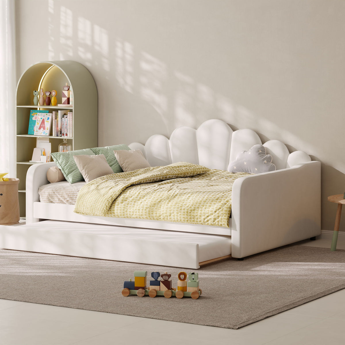 White upholstered daybed frame with shell-shaped headboard and lower storage drawers