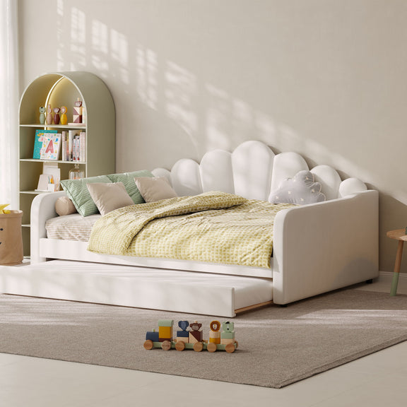 White upholstered daybed frame with shell-shaped headboard and lower storage drawers