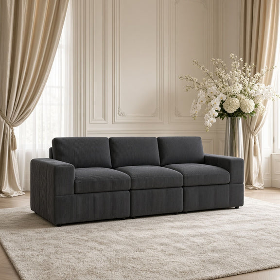 Dark gray modular sectional sofa with rounded back cushions and three seat blocks