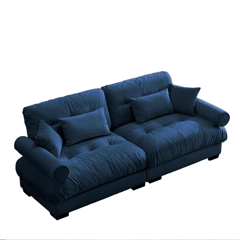Blue oversize sofa with tufted seat cushions and square back throw pillows