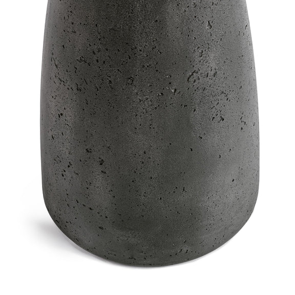 Outdoor accent table close-up of dark speckled pedestal with rounded base curve.