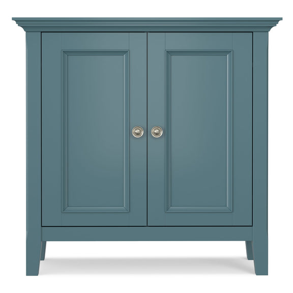 Blue low storage cabinet with two paneled doors and round metal knob pulls