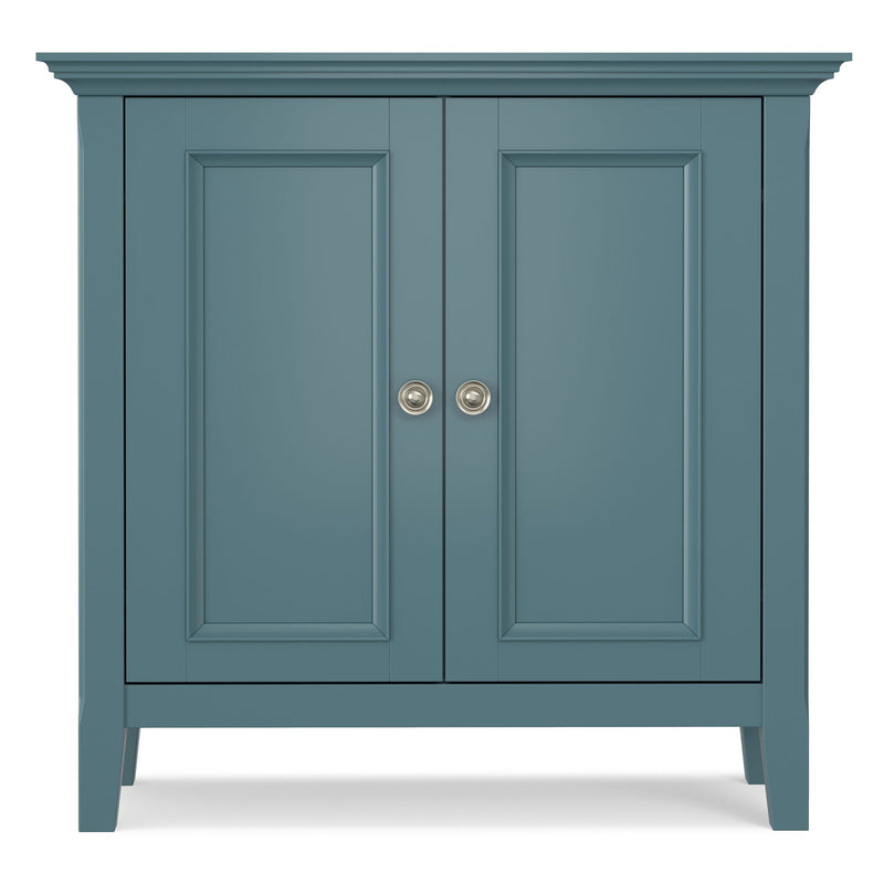 Blue low storage cabinet with two paneled doors and round metal knob pulls