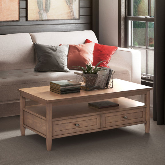 Rustic brown coffee table with open shelf and two drawers in a living room