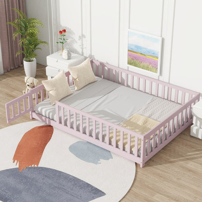 Pink full-size floor bed with white mattress and raised safety guardrails around